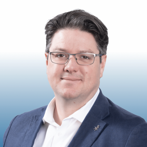 Professional headshot of an Equity commercial real estate team member wearing glasses and a navy blazer